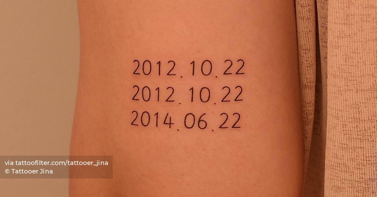 Meaningful dates tattooed on the tricep.