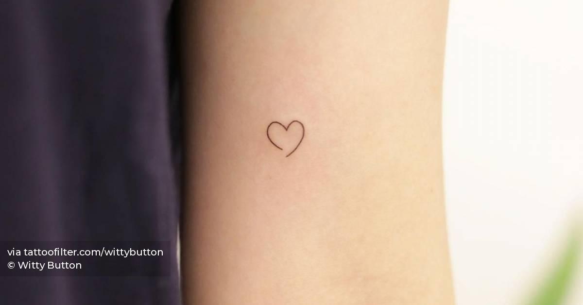 Minimalist heart tattooon the inner arm.