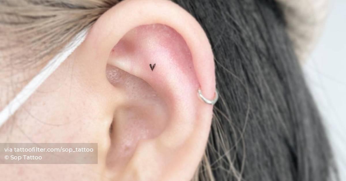 Micro heart tattoo located on the ear, minimalistic