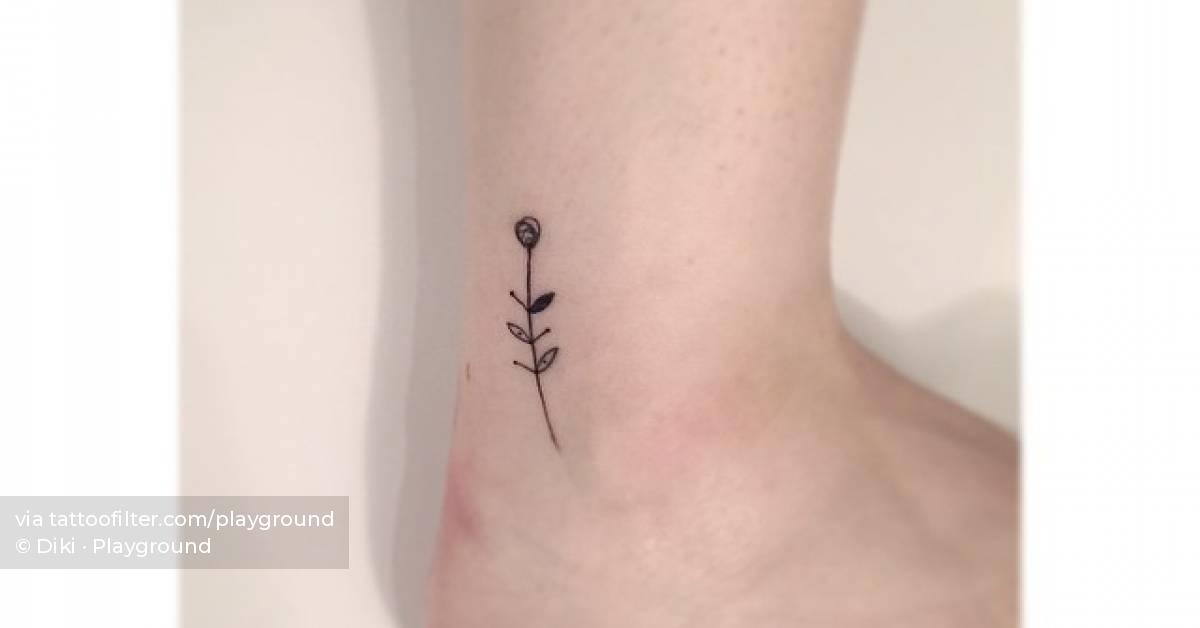 Fine line flower tattoo located on the ankle.