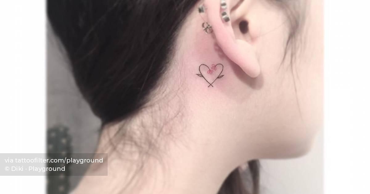 Fine line heart flower tattoo located behind the ear.