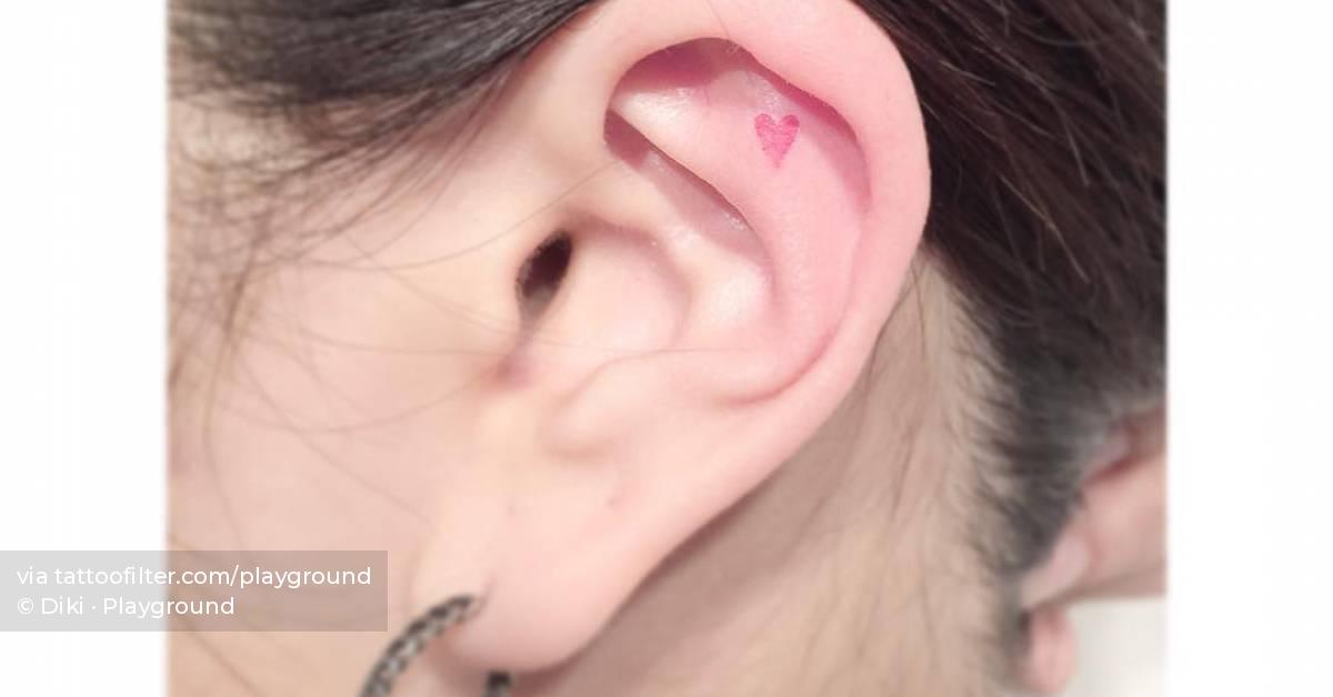 Tiny red heart tattoo done on the ear, minimalistic