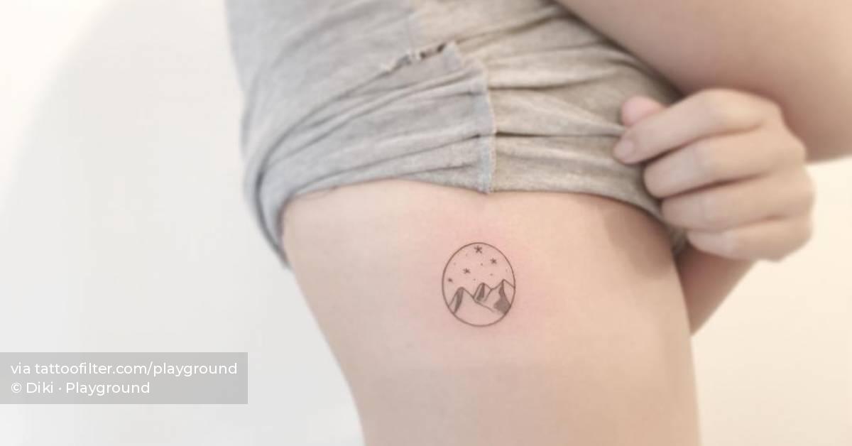 Tattoo of a mountain located on the rib, minimalistic