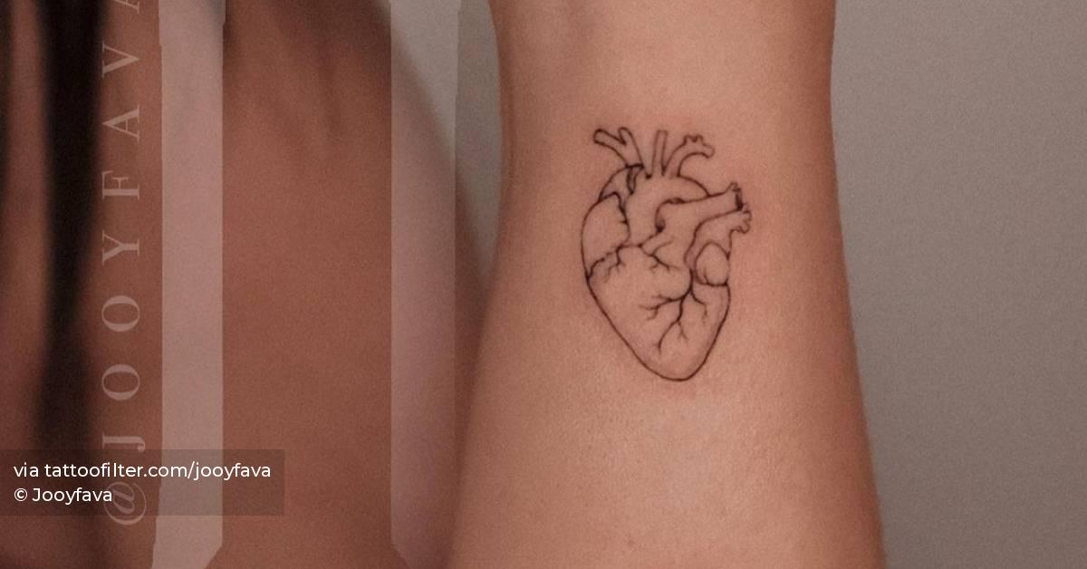 Fine line anatomical heart tattoo placed on the wrist.