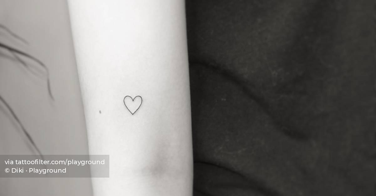 Minimalistic heart tattoo located on the upper arm.