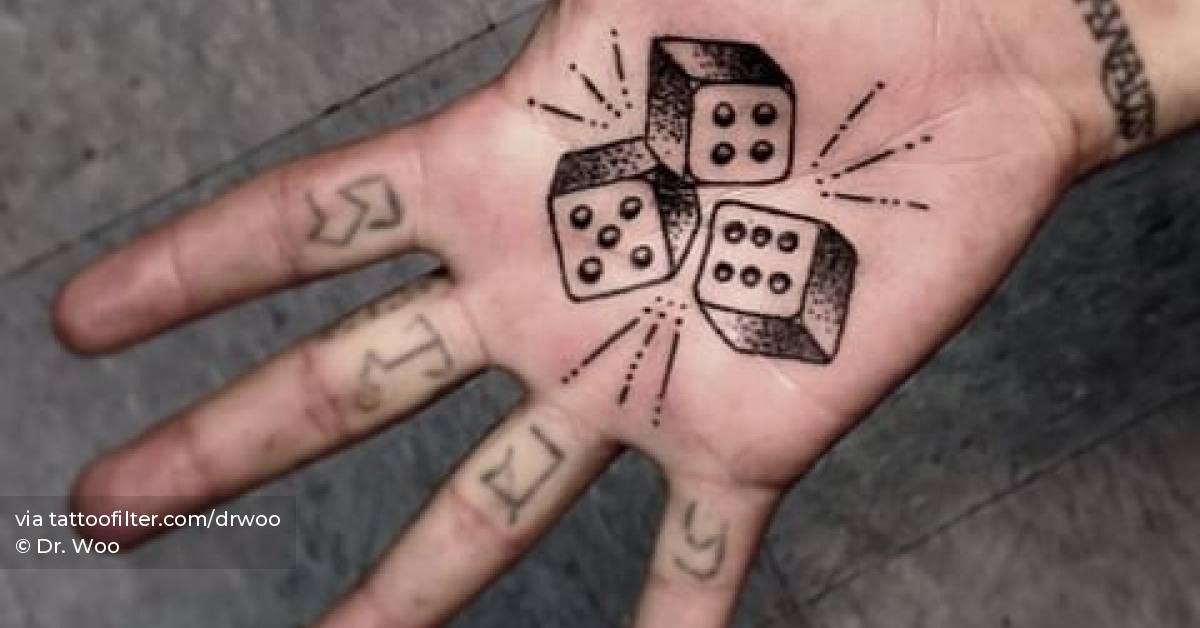 Traditional style dice tattooed on the palm.