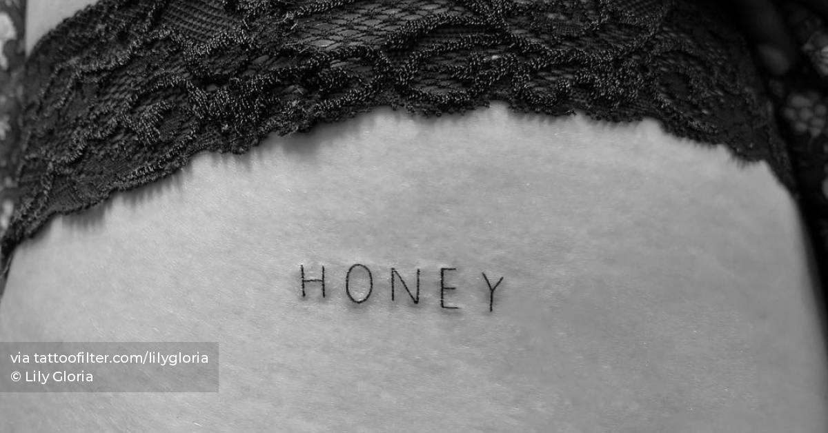 "Honey" lettering tattoo hand poked on the hip.