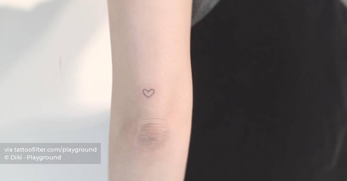 Tiny minimalistic heart tattoo located on the tricep.
