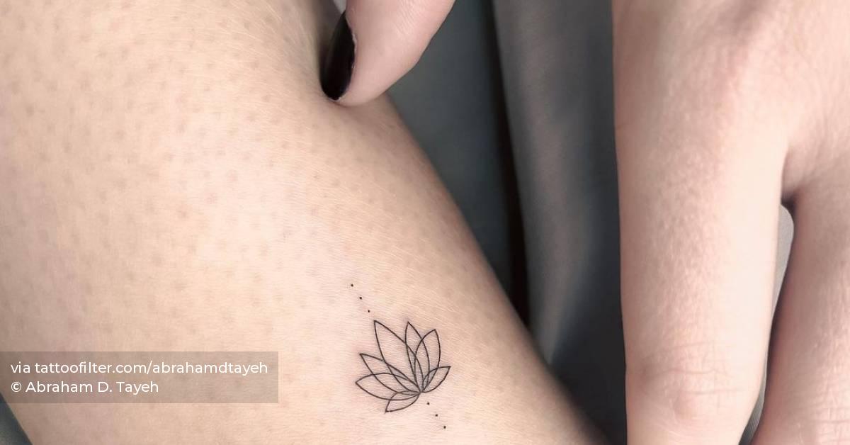 Fine line lotus flower tattoo done on the ankle.