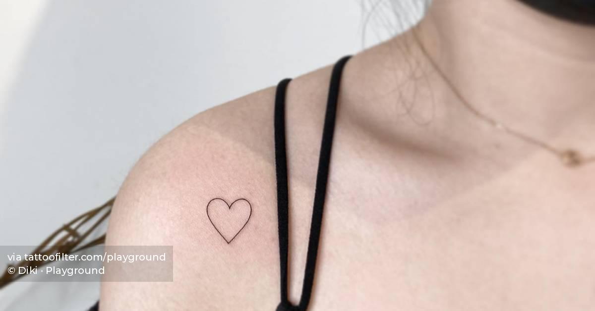 Minimalistic style heart tattoo located on the