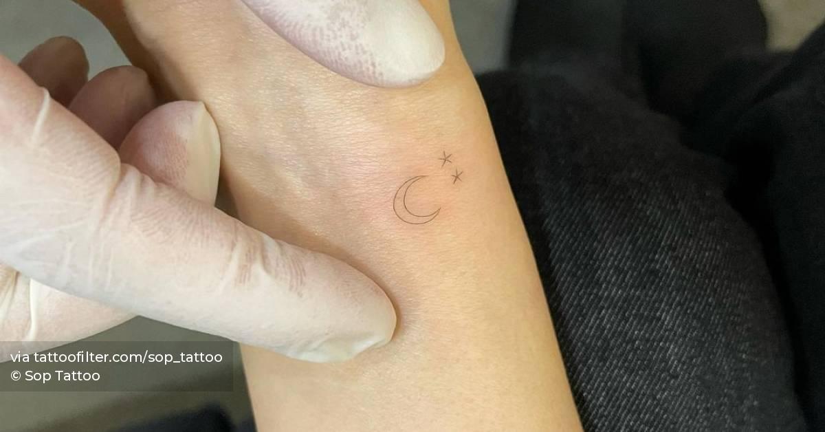Moon and stars tattoo located on the wrist, fine line