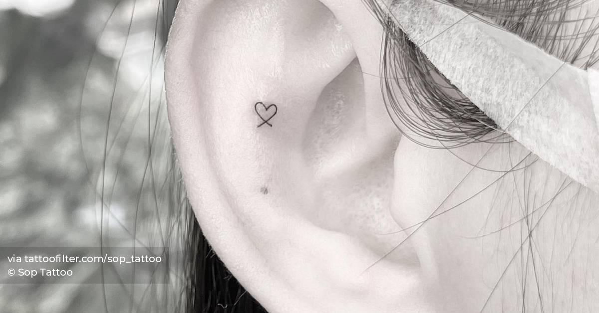 Super tiny heart tattoo done on the ear, minimalistic