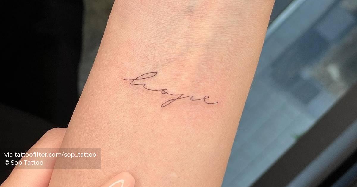 "Hope" lettering tattoo located on the wrist.