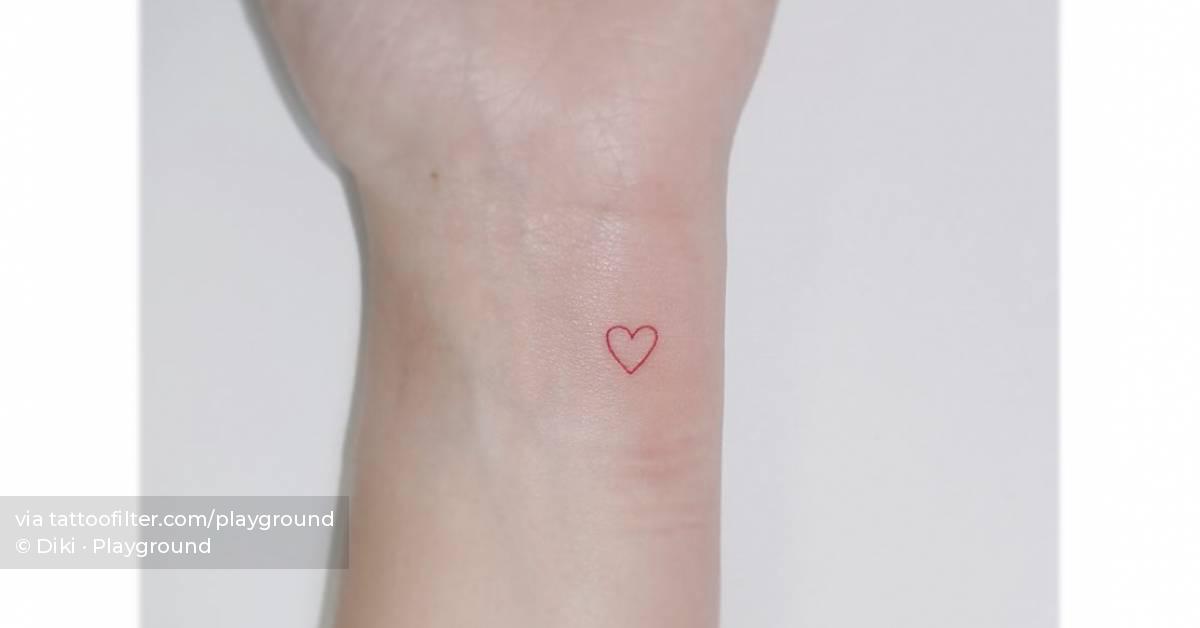 Tiny red heart tattoo located on the wrist,