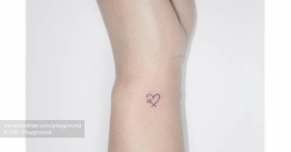 Minimalistic heart and flower tattoo located on the