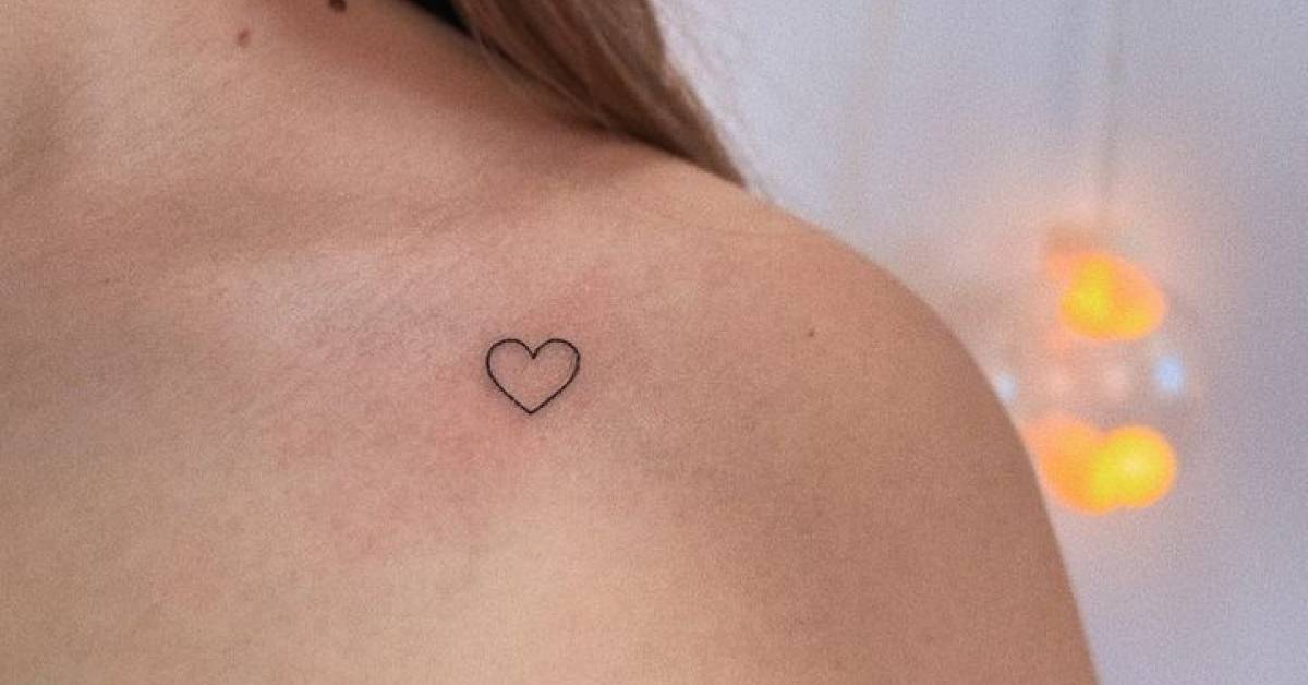 Minimalistic conventional heart tattoo located on the
