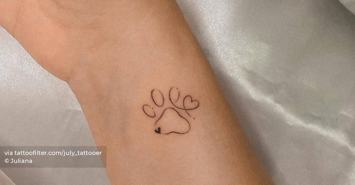 Minimalistic dog paw tattoo located on the wrist.