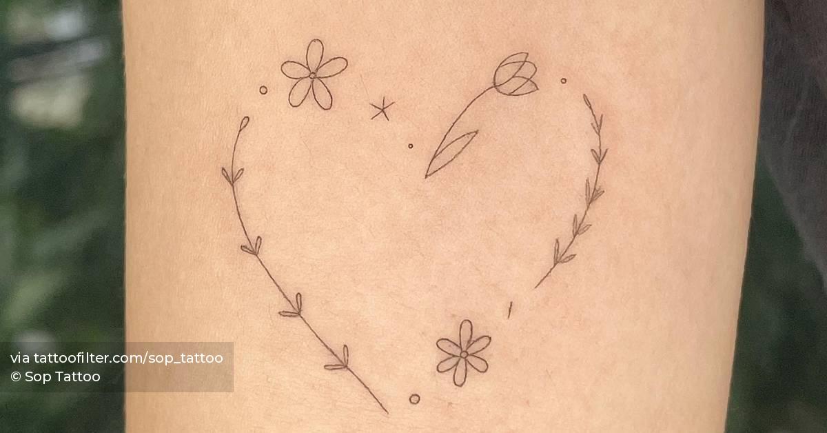 Fine line flower heart tattoo located on the inner