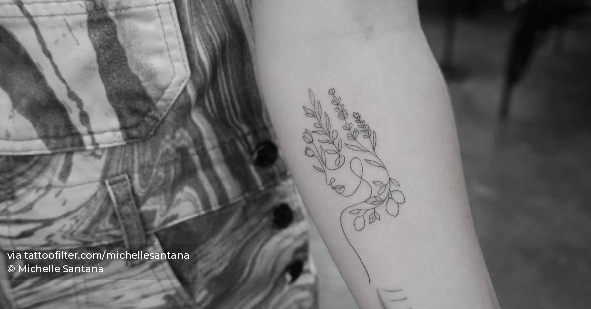 Fine line style flower head woman tattoo located on the