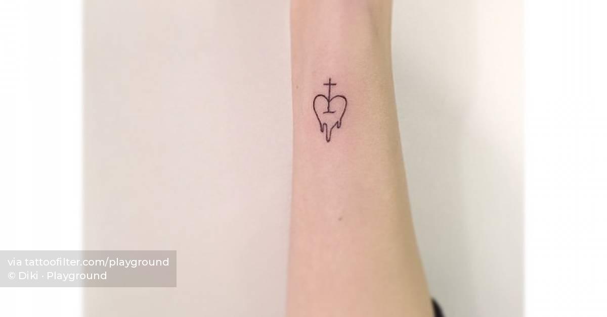 Minimalistic style heart and cross tattoo located on