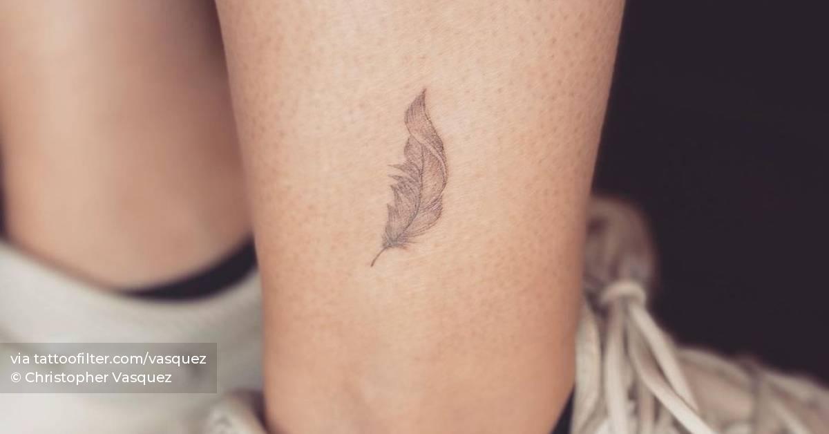 Single needle feather tattoo located on the ankle.