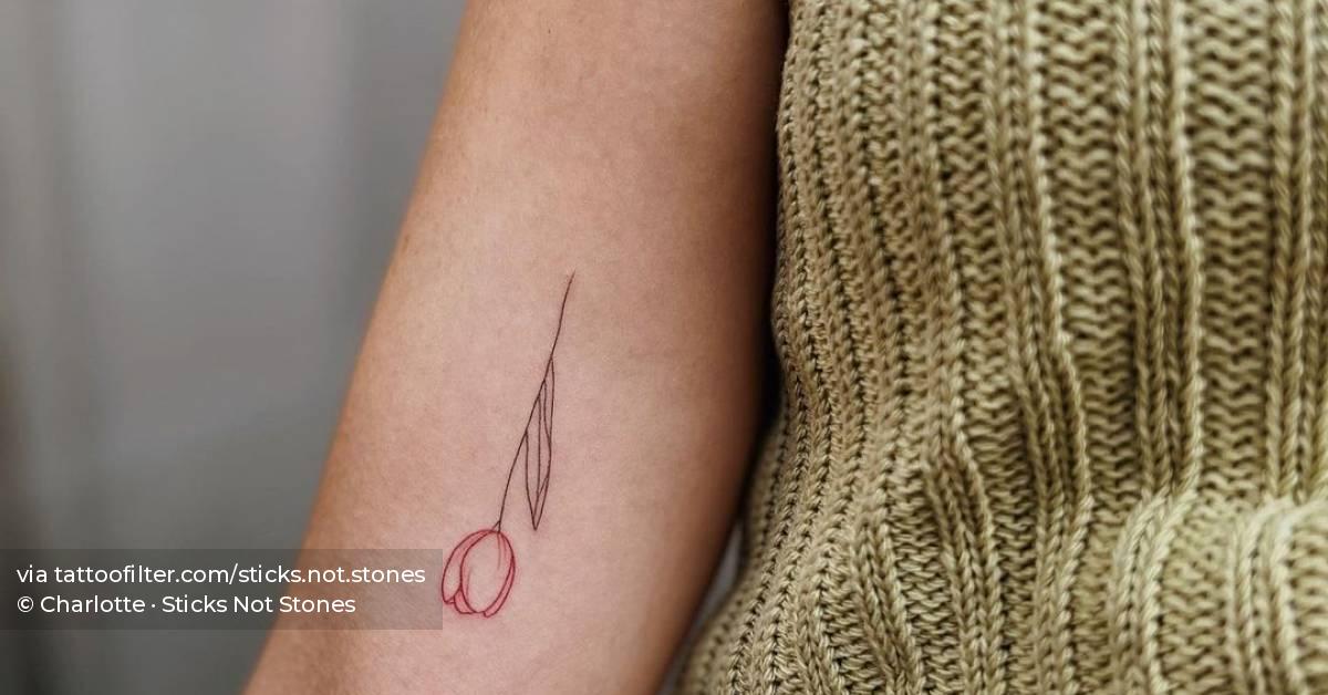 Fine line tulip tattoo hand poked on the inner arm.