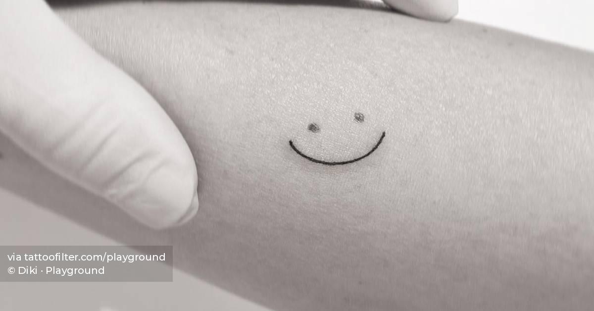 Smiley face birthmark cover up tattoo located on the