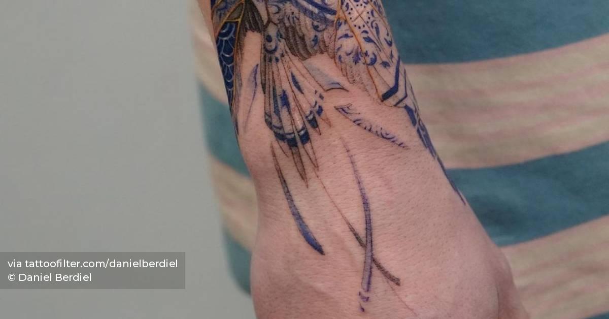 Micro-realistic Phoenix tattoo on the wrist.
