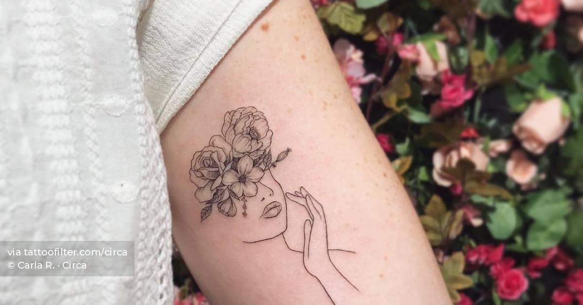 Fine line flower head woman tattoo on the inner
