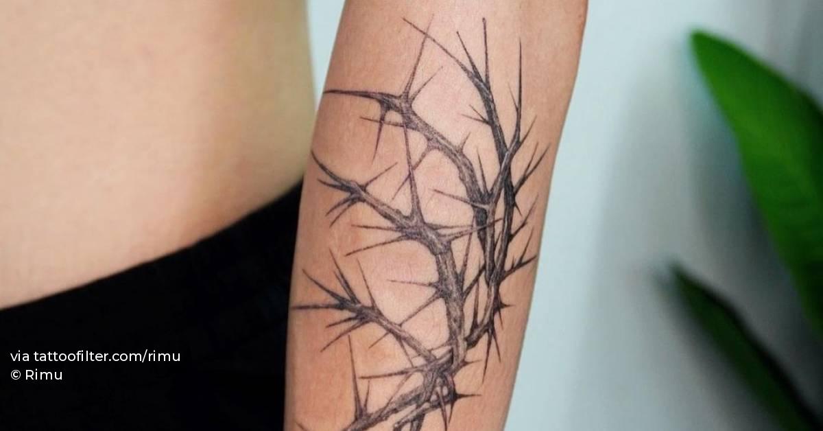Micro-realistic thorn tattoo located on the forearm.