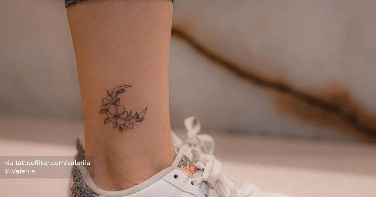 Fine line flower moon tattoo located on the ankle.