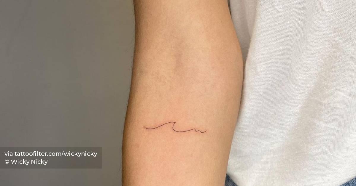 Minimalistic wave tattoo located on the inner arm.