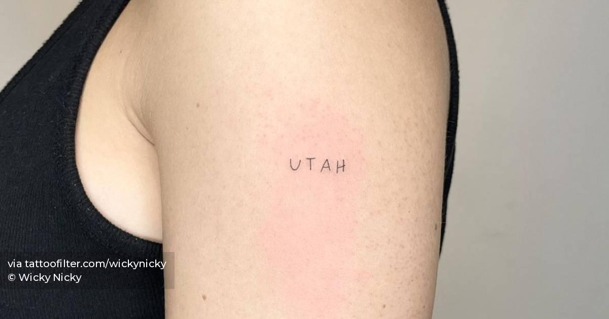 "Utah" lettering tattoo located on the upper arm.