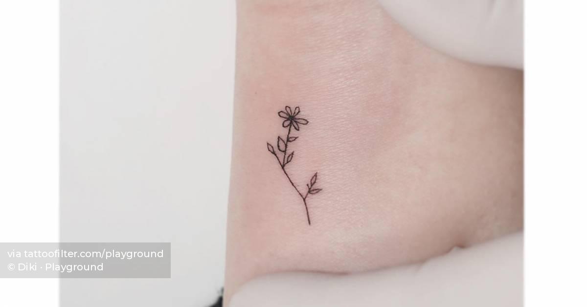 Fine line flower tattoo located on the wrist,