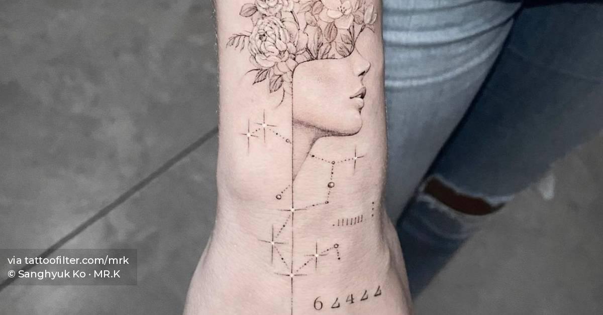 Single needle flower head woman tattoo located on the