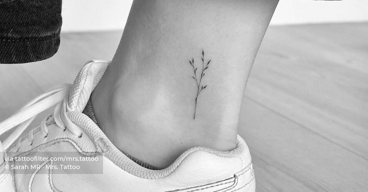 Fine line branch tattoo located on the ankle.