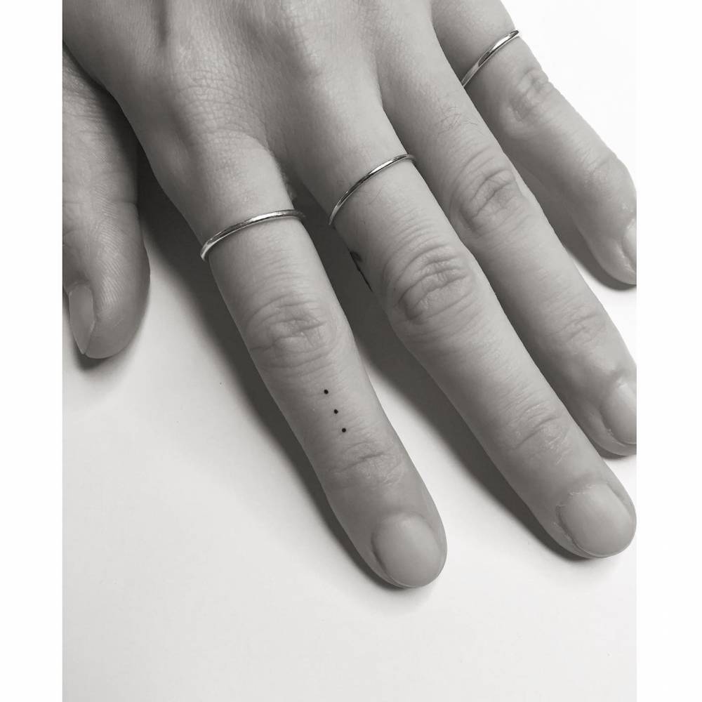 Minimalistic Dots Tattooed On The Finger 