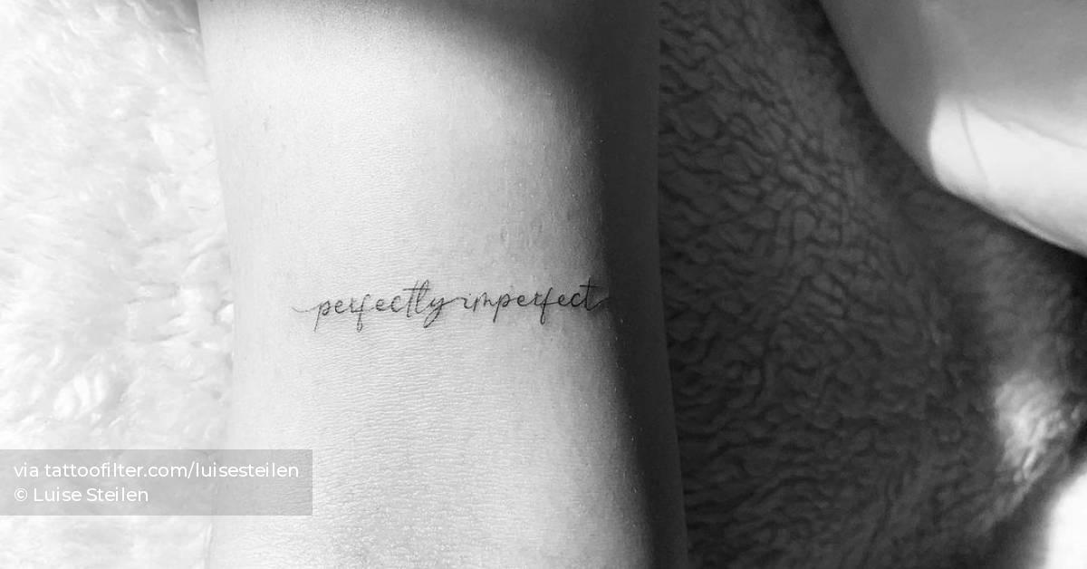 "Perfectly imperfect" lettering tattoo on the bicep.