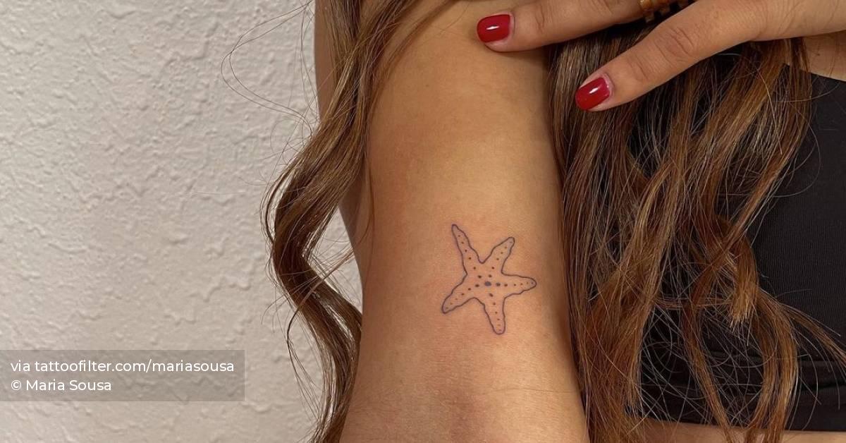 Minimalist starfish tattoo on the bicep.