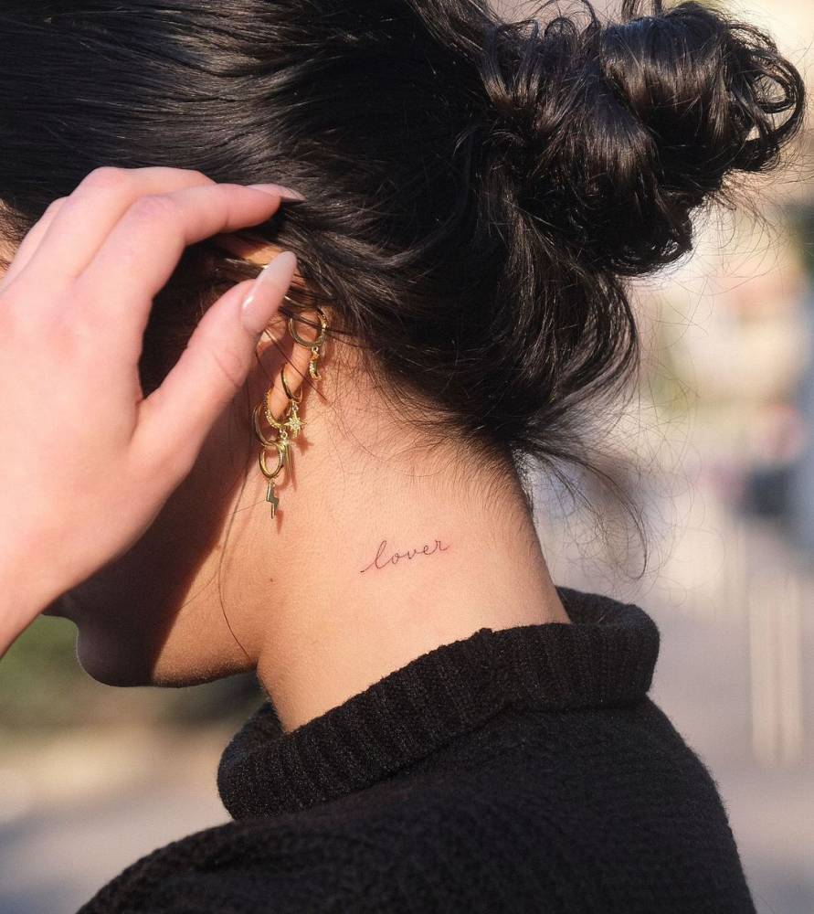 Tattoo Of The Word lover Located On The Neck 
