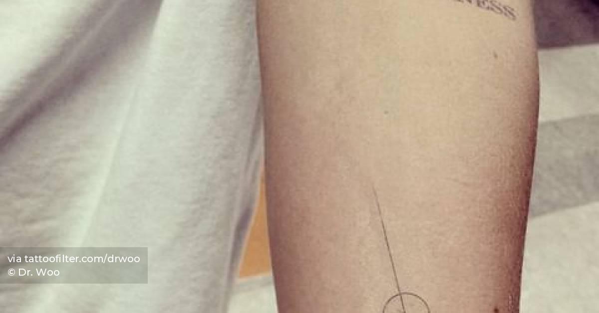 Minimalistic style line and circle tattoo located on