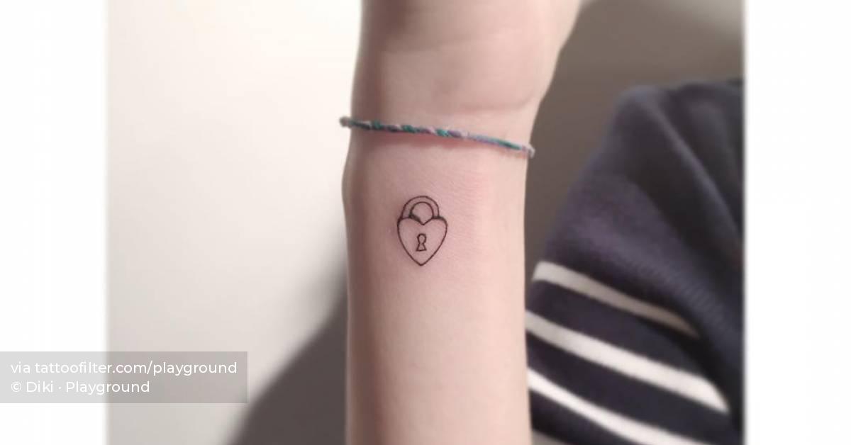Minimalistic padlock heart tattoo placed on the wrist.