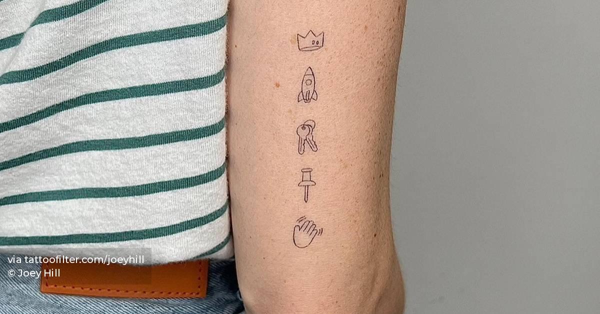 Healed single needle emojis tattooed on the tricep.