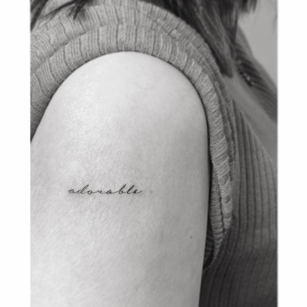 Tattoo Of The Word adorable Located On The Upper Arm 