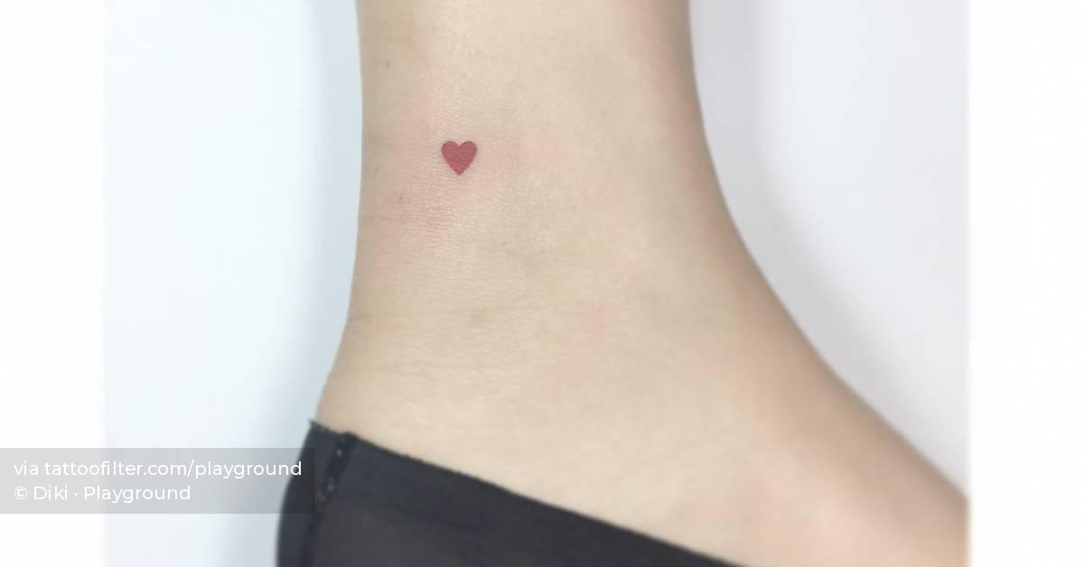 Teeny tiny red heart tattoo located on the ankle,