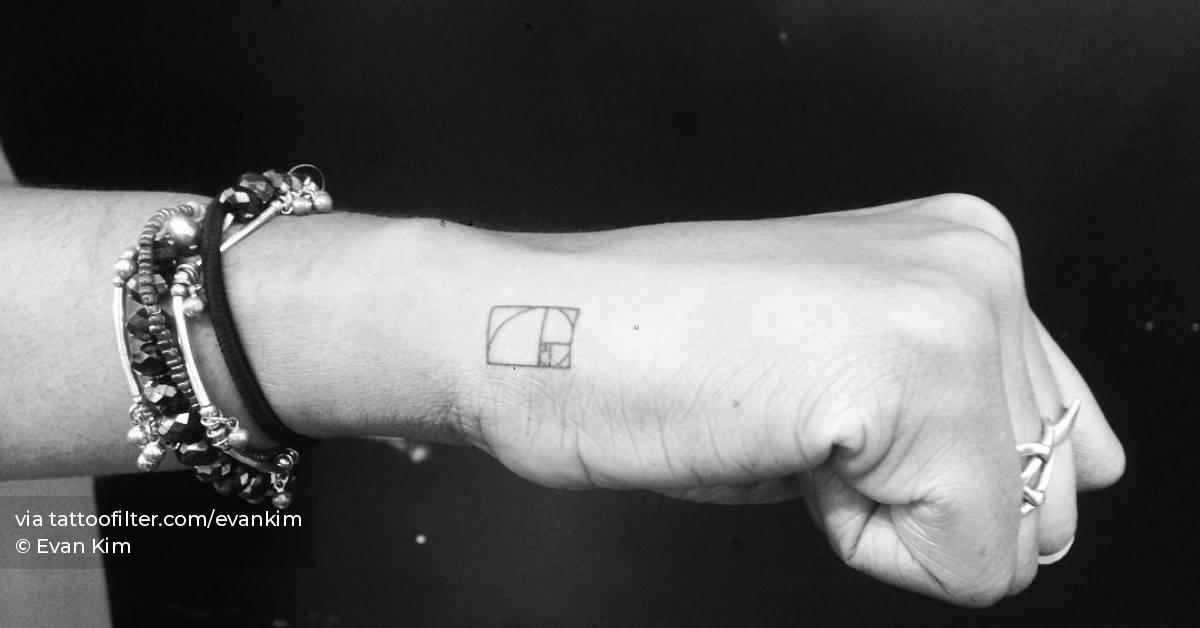 Minimalistic style golden spiral tattoo located on the