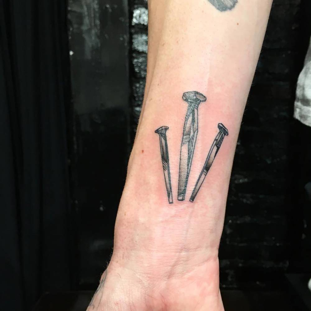 Illustrative Style Nails Tattoo Located On The Wrist 