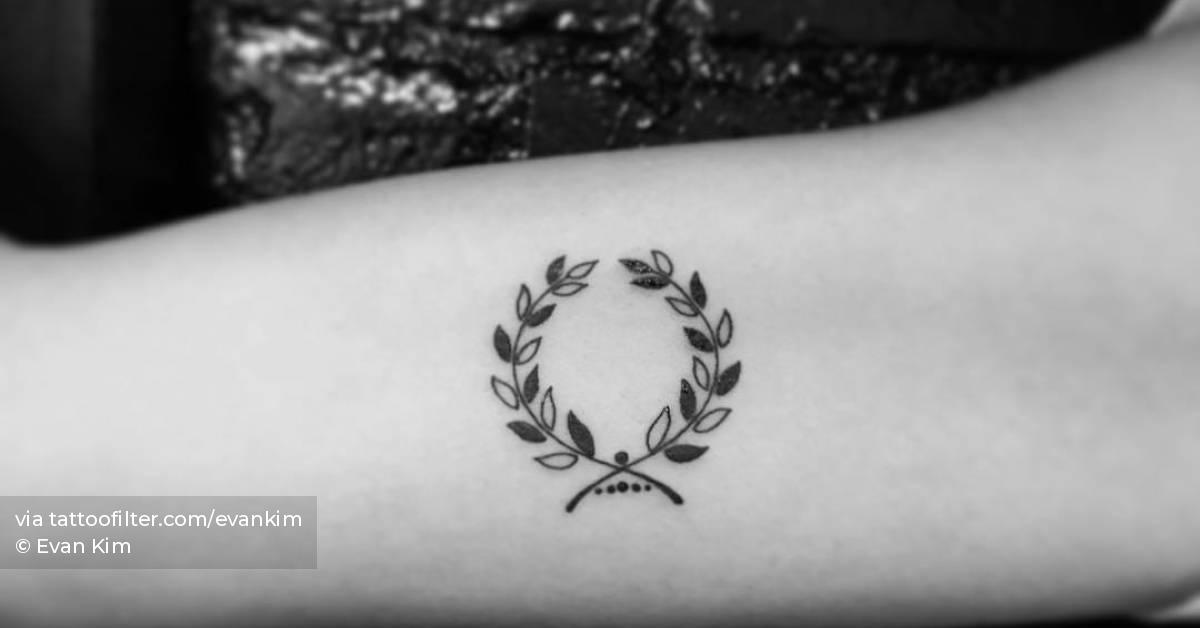 Laurel wreath tattoo located on the inner arm,
