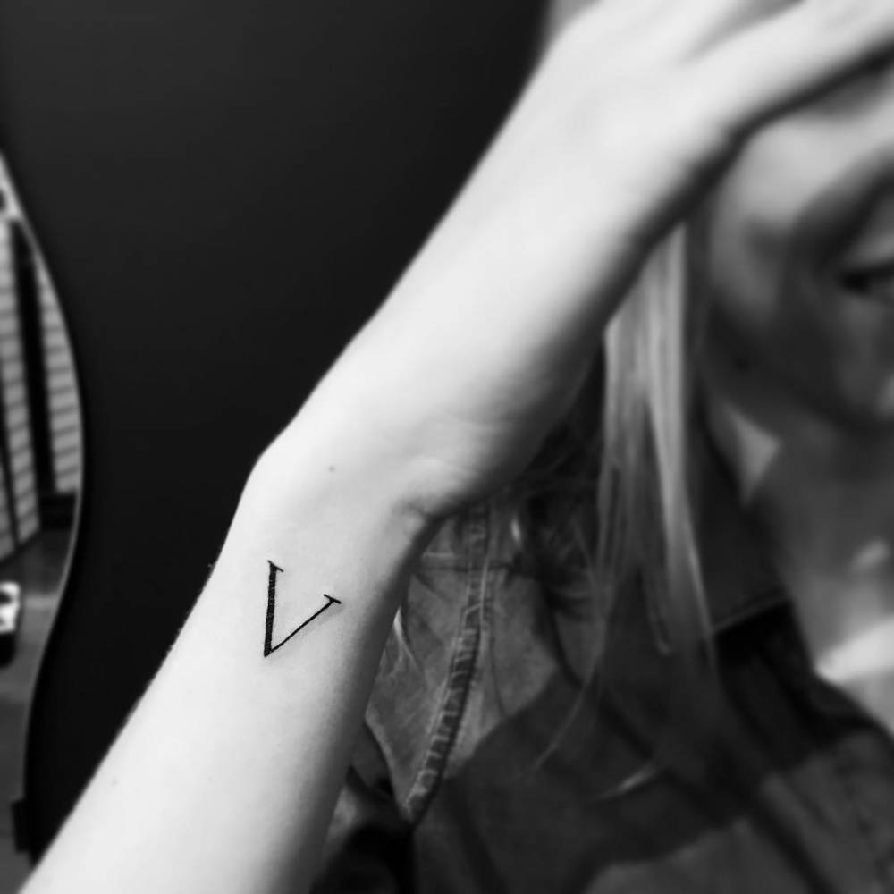 Minimalistic Letter V Tattoo Located On The Wrist 