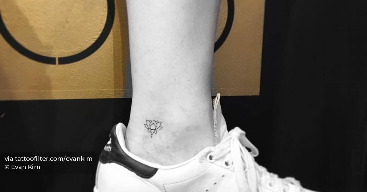Fine line lotus flower tattoo located on the ankle.